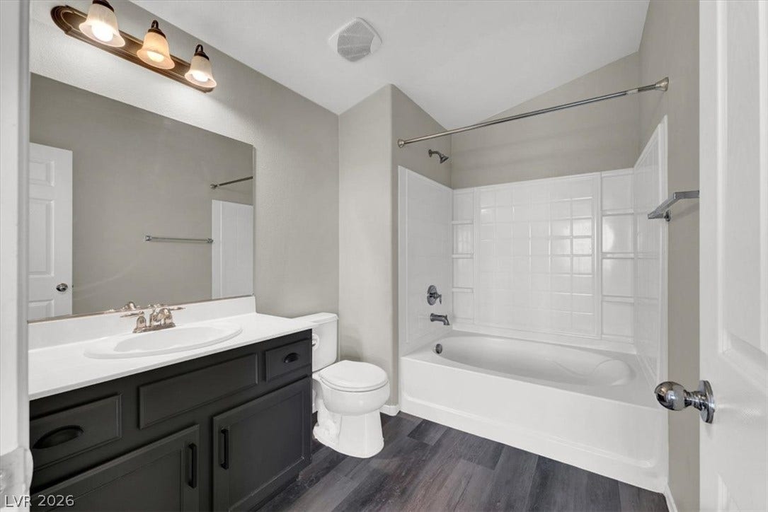 Vaulted ceilings and a deep soaking tub anchor this modern full bath.