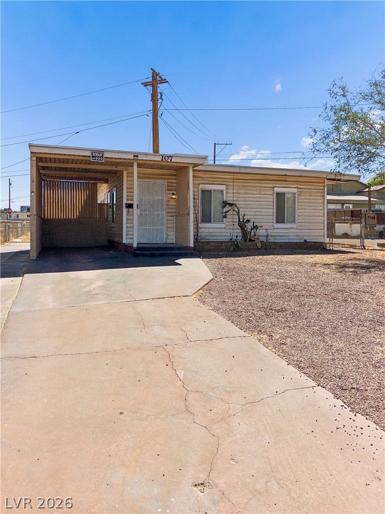107 W Victory Road, Henderson, NV 89015 An inviting single-story home presents low-maintenance landscaping and an attached carport.