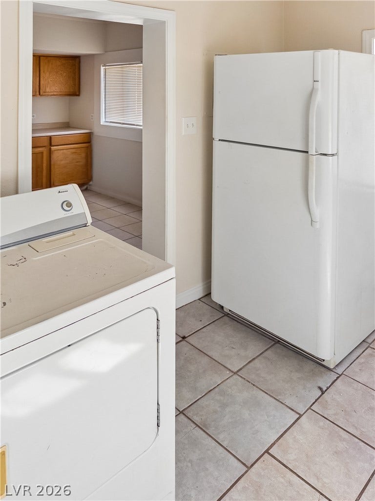 107 W Victory Road, Henderson, NV 89015 Tiled flooring runs throughout this practical utility space connecting directly to the kitchen area.