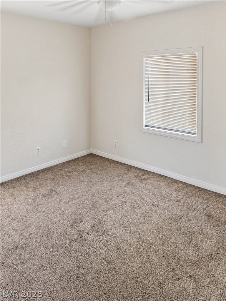 107 W Victory Road, Henderson, NV 89015 Plush carpeting and a classic window frame establish a comfortable atmosphere in this bedroom.