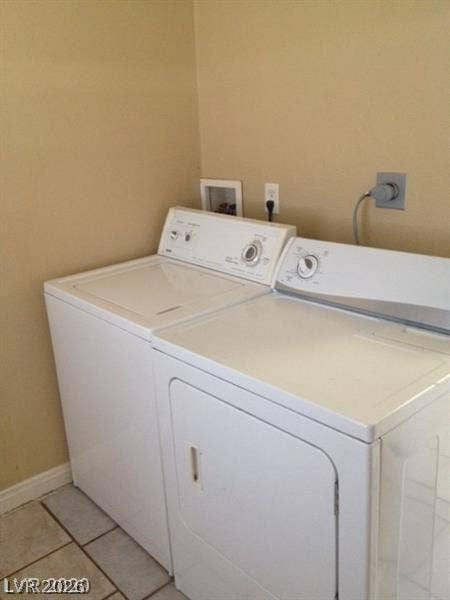107 W Victory Road, Henderson, NV 89015 Tiled flooring and neutral walls frame this practical laundry area.