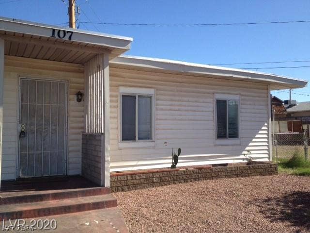 107 W Victory Road, Henderson, NV 89015 A classic exterior featuring horizontal siding and a shaded front porch with concrete steps.