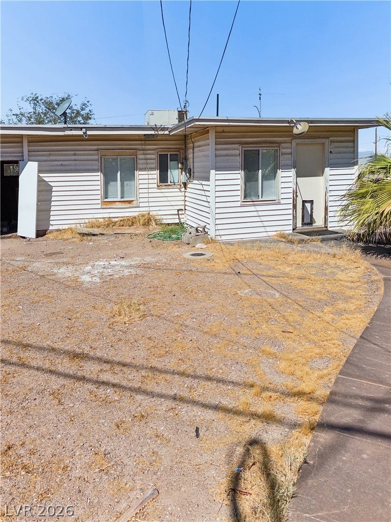 107 W Victory Road, Henderson, NV 89015 Horizontal siding and simple framing define the back exterior of this one-story structure.