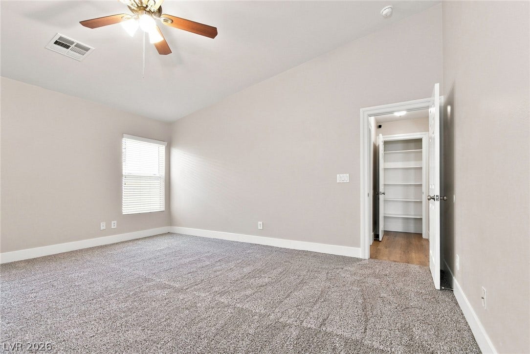 6059 Camden Cove Street, North Las Vegas, NV 89081 High vaulted ceilings and plush carpeting define this airy bedroom space.