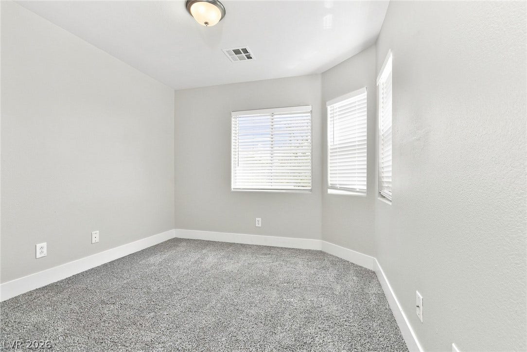 6059 Camden Cove Street, North Las Vegas, NV 89081 Plush wall-to-wall carpeting and multiple windows define this versatile room.