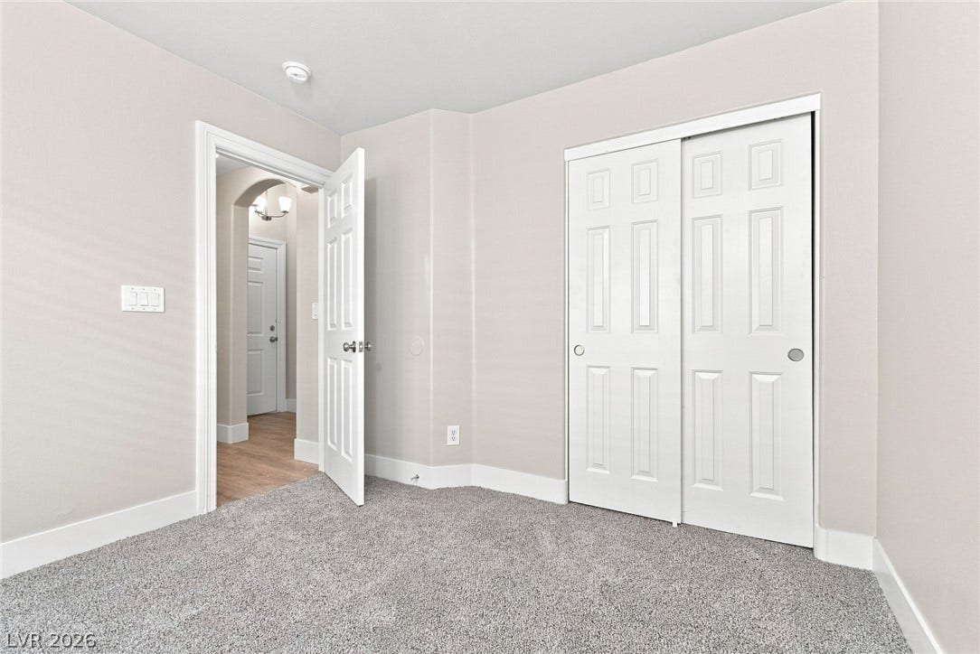 6059 Camden Cove Street, North Las Vegas, NV 89081 Soft carpeting underfoot enhances this comfortable bedroom featuring a sliding closet door.