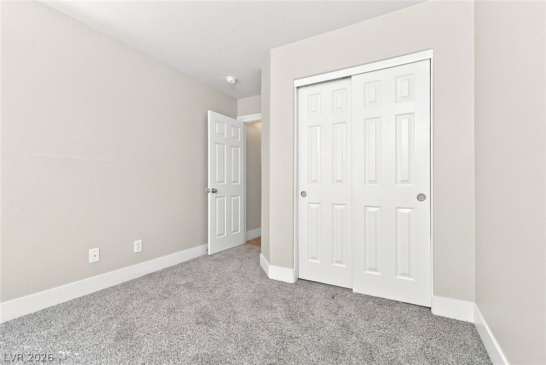 6059 Camden Cove Street, North Las Vegas, NV 89081 Smooth plaster walls meet soft textured flooring in this versatile bedroom space.