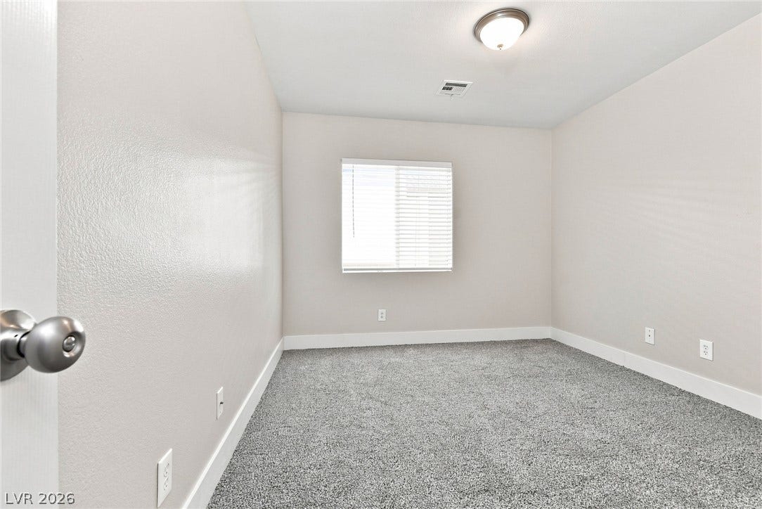 6059 Camden Cove Street, North Las Vegas, NV 89081 Plush carpeting anchors this versatile room under a neutral color palette.