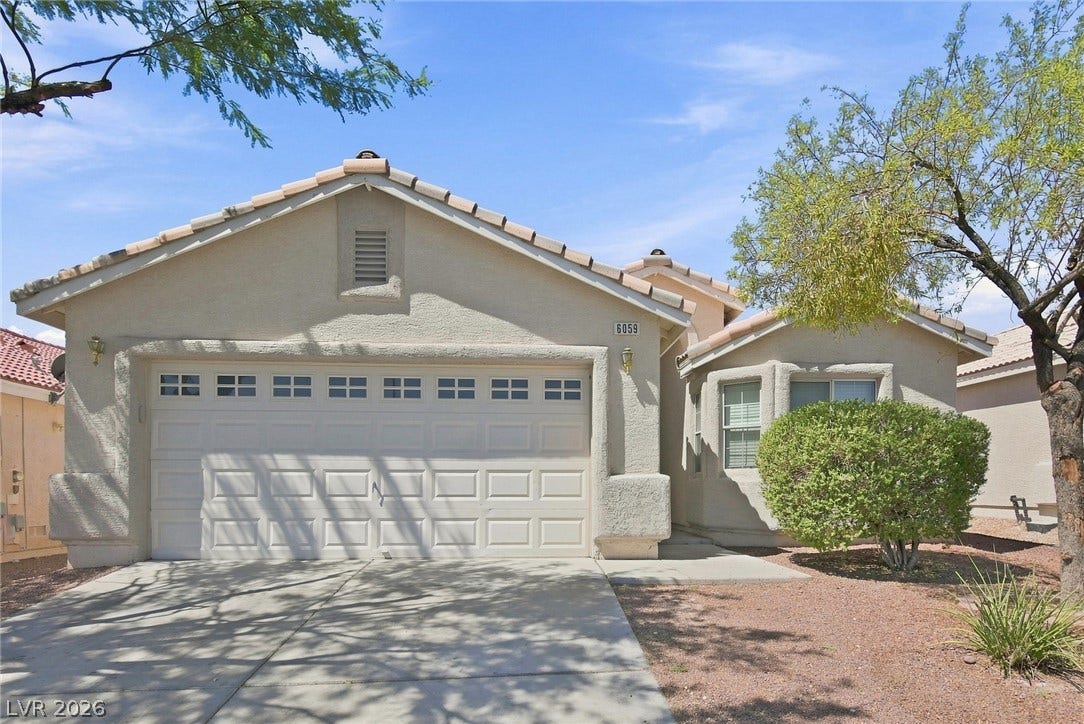 6059 Camden Cove Street, North Las Vegas, NV 89081 Tiled rooflines and stucco exterior walls create classic architectural appeal.
