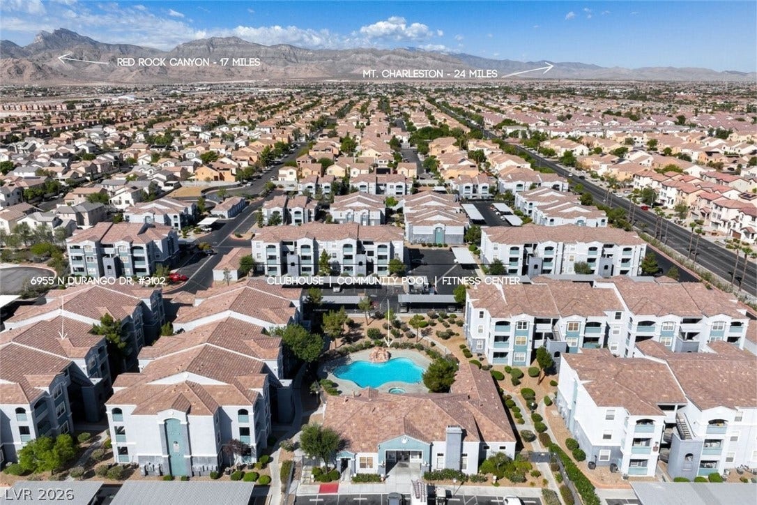 6955 N Durango Drive, #3102, Las Vegas, NV 89149 Aerial view showcasing the west facing mountains, community pool, clubhouse and fitness center, with Red Rock Canyon and Mt. Charleston in the distance.