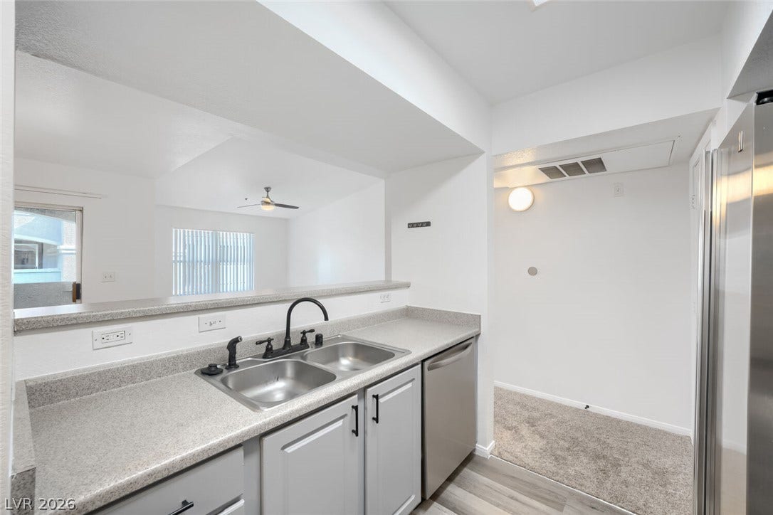 6955 N Durango Drive, #3102, Las Vegas, NV 89149 Open-concept kitchen with breakfast bar overlooking the spacious living area, creating an easy flow for everyday living and entertaining.