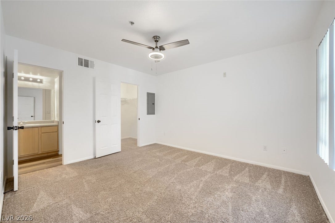 6955 N Durango Drive, #3102, Las Vegas, NV 89149 Spacious guest bedroom with new carpet and fresh paint, featuring a walk-in closet and direct access to the guest bathroom.