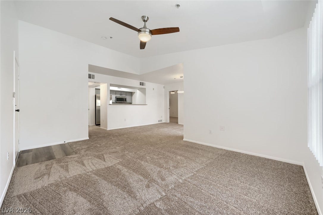 6955 N Durango Drive, #3102, Las Vegas, NV 89149 Freshly painted living room with new carpet and a desirable split-bedroom layout, with the primary bedroom separated from the guest bedroom.