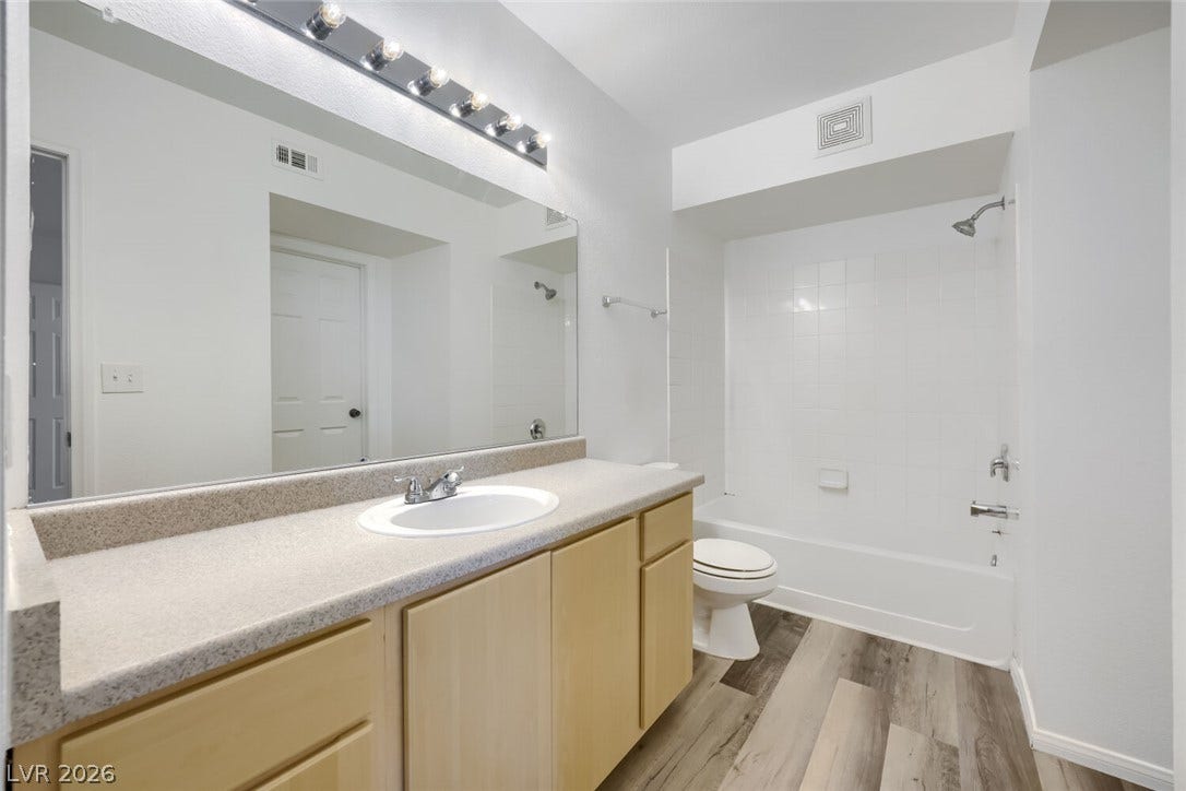6955 N Durango Drive, #3102, Las Vegas, NV 89149 An expansive vanity mirror highlights this bathroom complete with new paint and LVP flooring