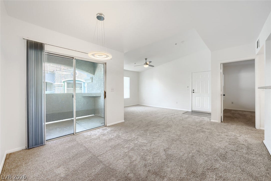6955 N Durango Drive, #3102, Las Vegas, NV 89149 Open and airy living and dining areas with high ceilings, new carpet, new paint and direct access to the balcony.