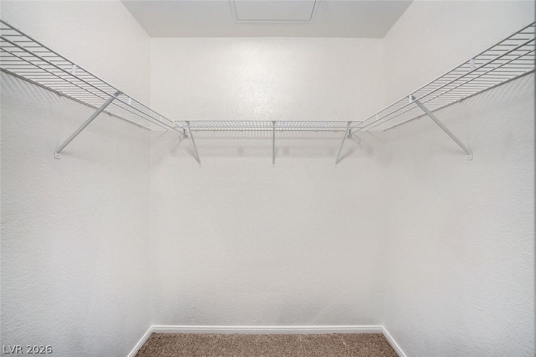 6955 N Durango Drive, #3102, Las Vegas, NV 89149 A spacious walk-in closet features wall-mounted shelving, new carpet and paint.