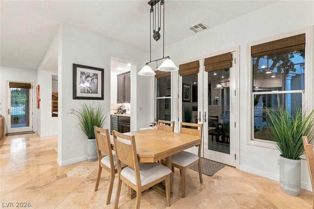 12056 Royal Dolnoch Court, Las Vegas, NV 89141 Polished tile flooring and tall glass doors elevate this inviting dining space.