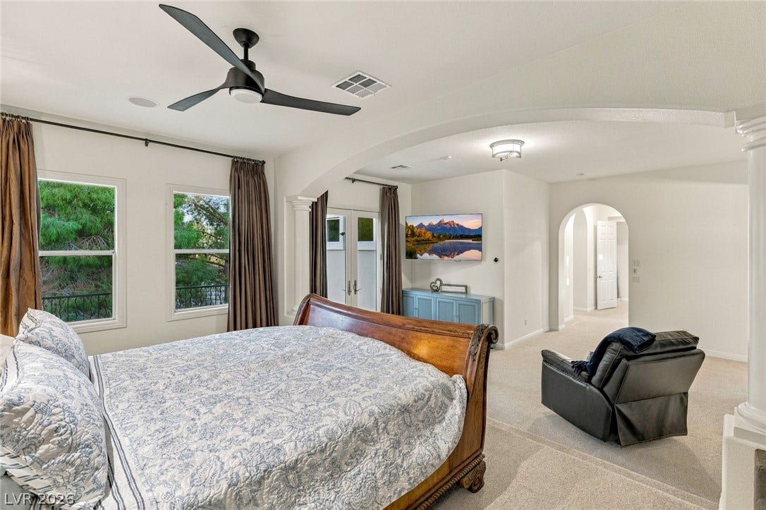 12056 Royal Dolnoch Court, Las Vegas, NV 89141 Thick carpeting and classic arched doorways define this spacious bedroom suite.