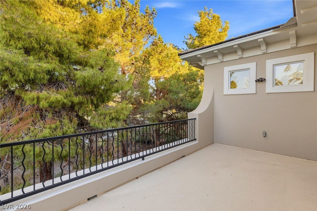 12056 Royal Dolnoch Court, Las Vegas, NV 89141 Mature trees frame the view from this private elevated balcony with stucco and tile details.