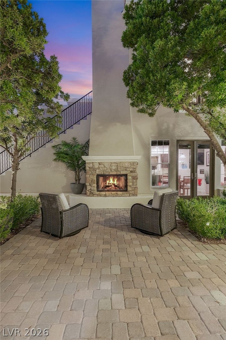 12056 Royal Dolnoch Court, Las Vegas, NV 89141 An inviting stone fireplace serves as the centerpiece of this intimate paver patio.