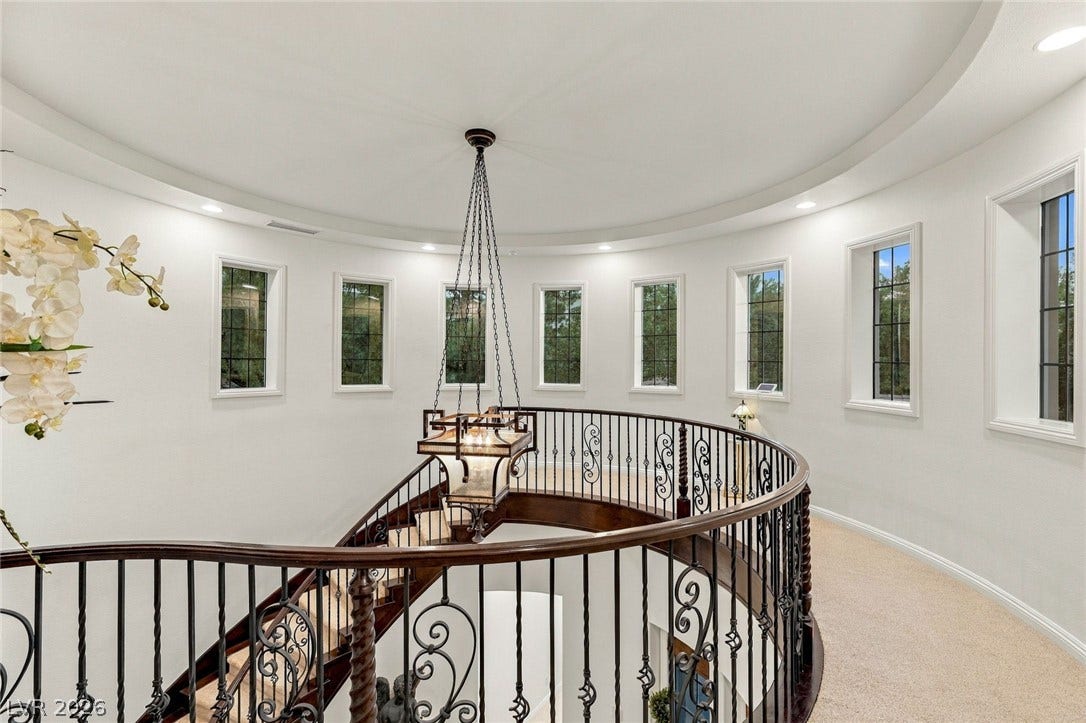 12056 Royal Dolnoch Court, Las Vegas, NV 89141 An elegant curved staircase winds below a circular gallery illuminated by a ring of windows.