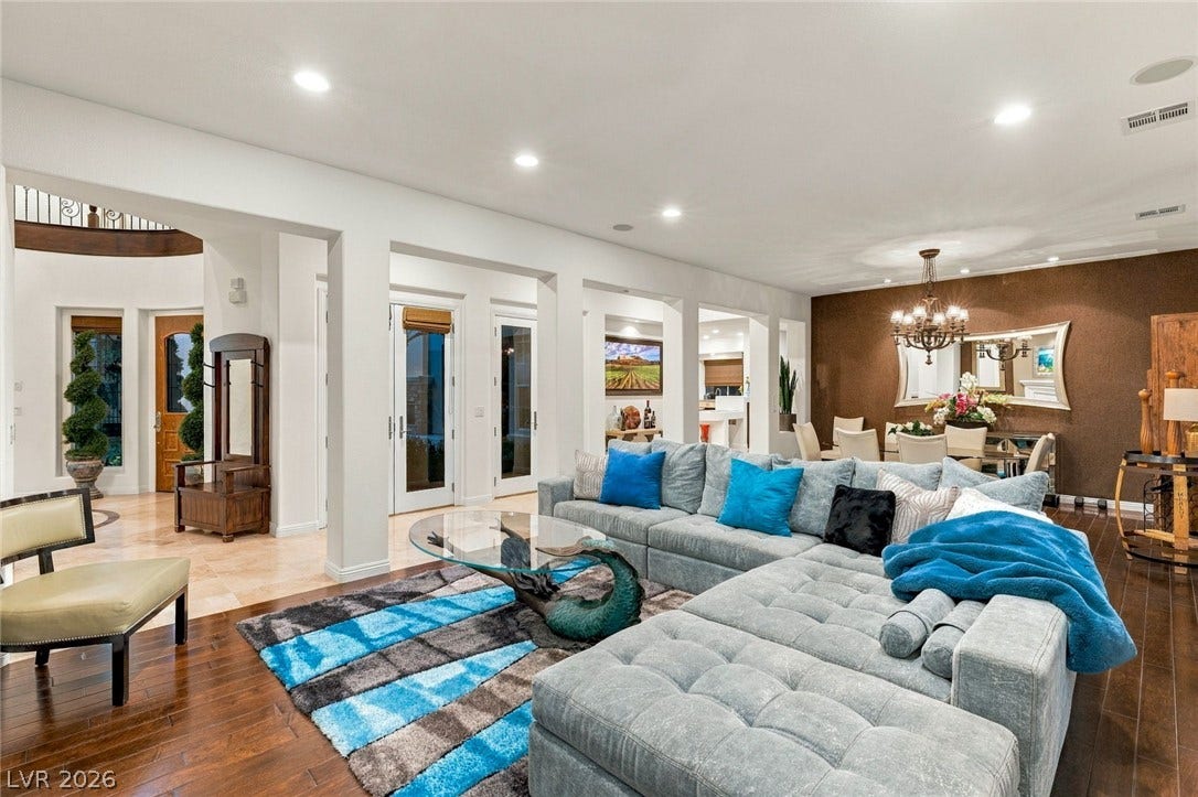 12056 Royal Dolnoch Court, Las Vegas, NV 89141 Rich hardwood floors complement an airy layout transitioning from cozy living to formal dining.