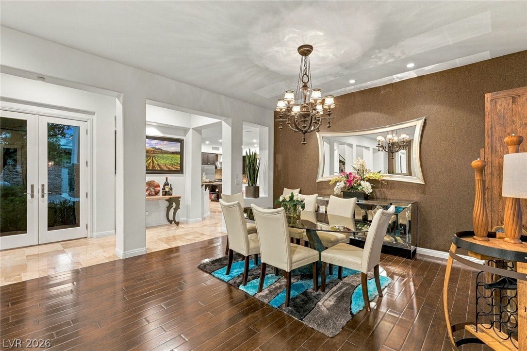 12056 Royal Dolnoch Court, Las Vegas, NV 89141 Gleaming hardwood floors and an elegant chandelier anchor this classic formal dining room.
