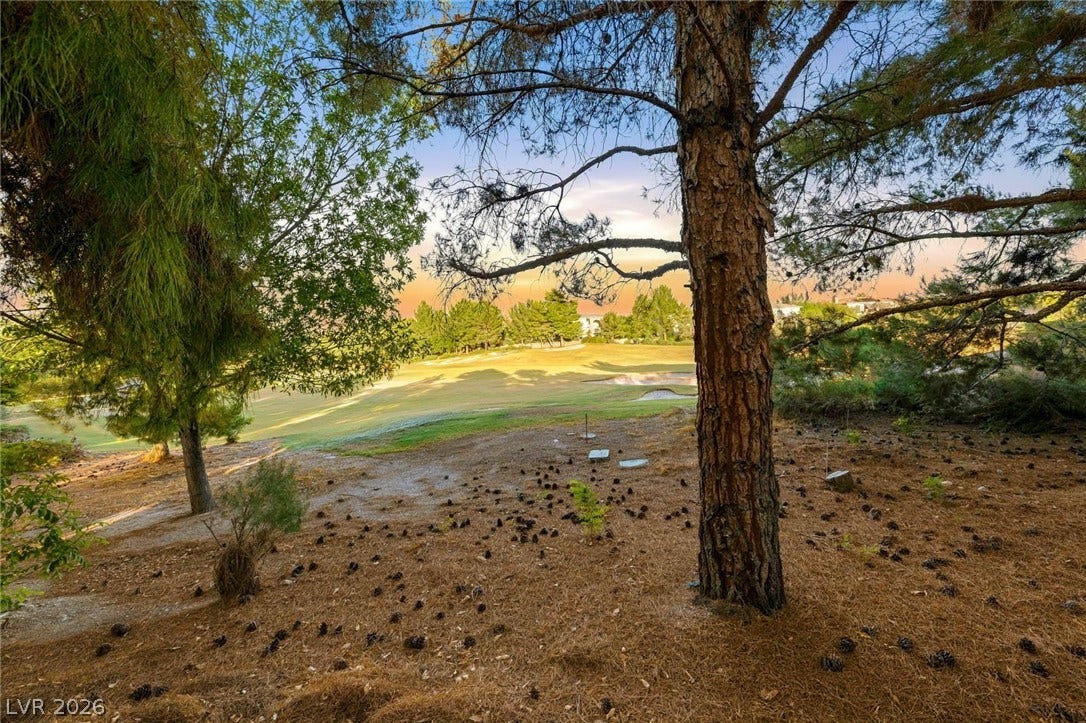 12056 Royal Dolnoch Court, Las Vegas, NV 89141 Mature trees frame a peaceful setting overlooking the rolling fairways of the golf course.
