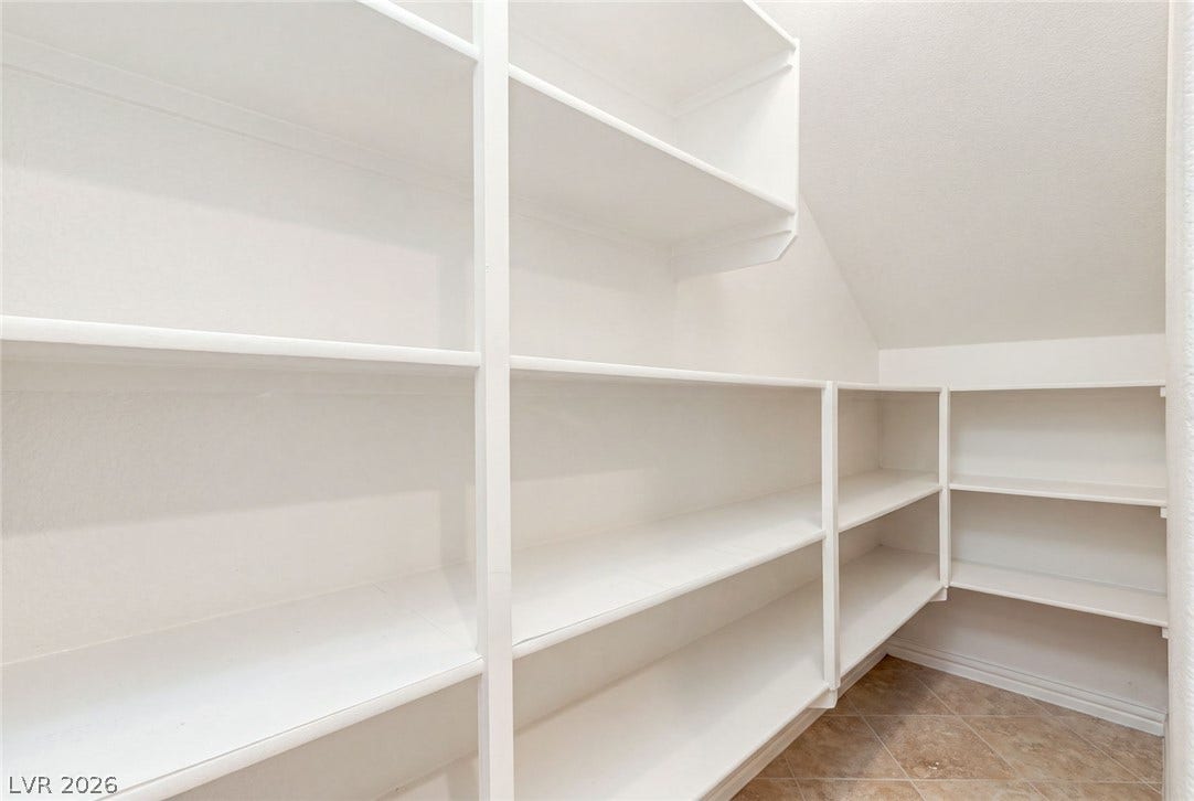 12056 Royal Dolnoch Court, Las Vegas, NV 89141 Generous built-in shelving maximizes storage potential under a sloped ceiling.