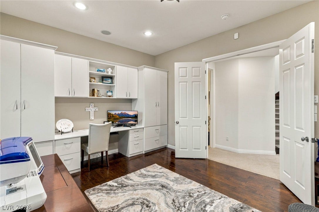 12056 Royal Dolnoch Court, Las Vegas, NV 89141 Rich hardwood flooring pairs beautifully with custom built-in cabinetry in this functional workspace.