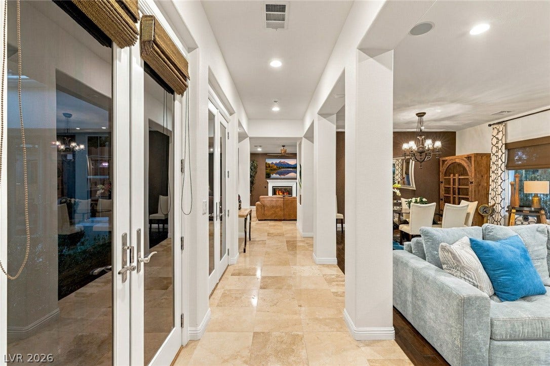 12056 Royal Dolnoch Court, Las Vegas, NV 89141 Gleaming tile floors guide the eye down a grand hallway flanked by architectural pillars.