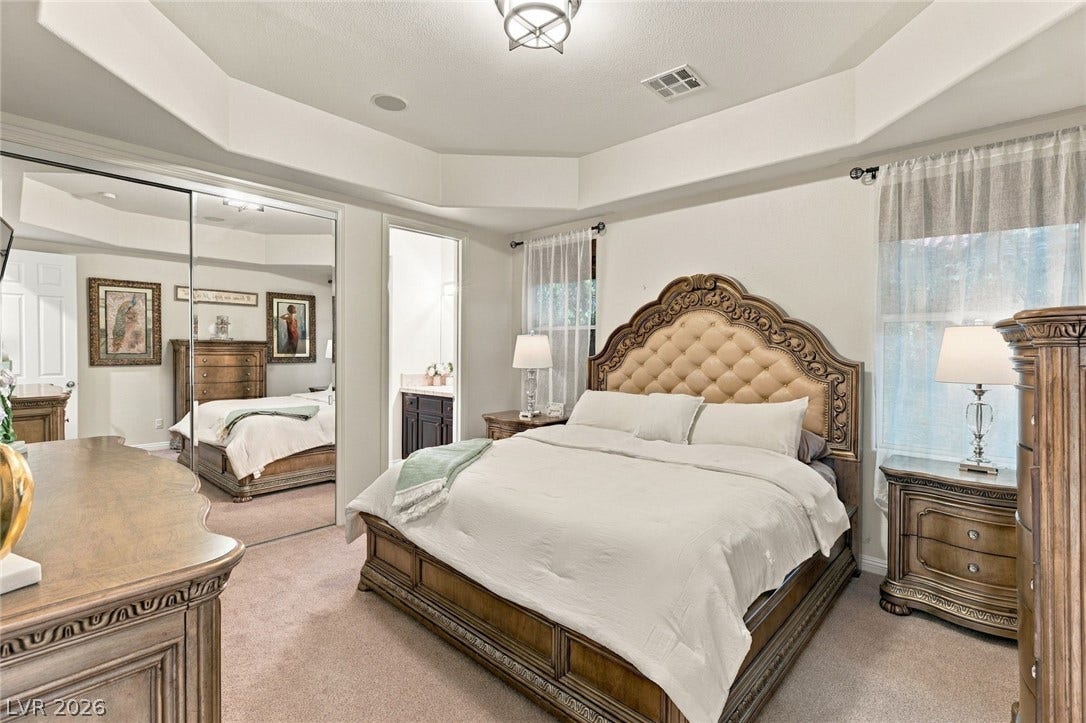 12056 Royal Dolnoch Court, Las Vegas, NV 89141 An elegant tray ceiling and soft carpeting define this inviting bedroom space.