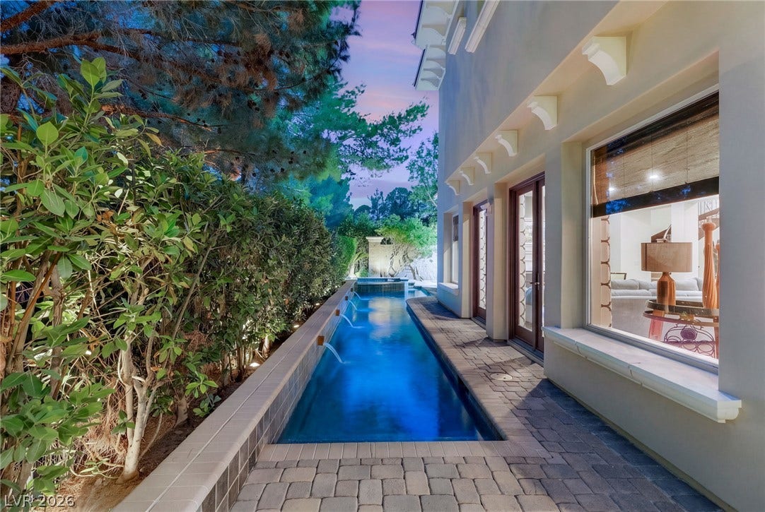 12056 Royal Dolnoch Court, Las Vegas, NV 89141 An elegant lap pool runs alongside the stone paver patio of this beautiful home.