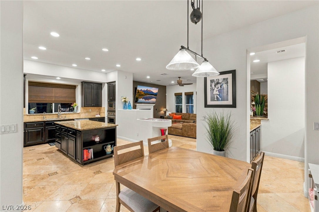 12056 Royal Dolnoch Court, Las Vegas, NV 89141 An open floorplan seamlessly connects the dining area to the kitchen and living spaces.