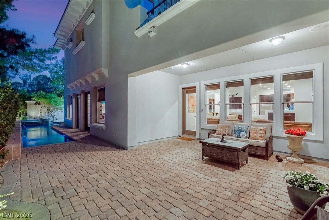 12056 Royal Dolnoch Court, Las Vegas, NV 89141 An inviting covered patio featuring brick pavers overlooks a private pool area.