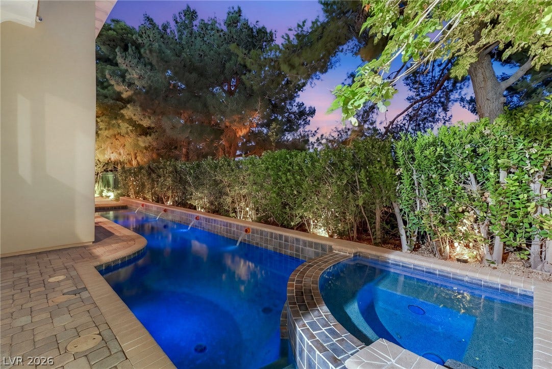 12056 Royal Dolnoch Court, Las Vegas, NV 89141 Lush landscaping and stone pavers surround a tranquil pool and integrated spa.