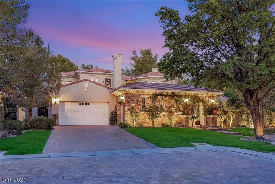 12056 Royal Dolnoch Court, Las Vegas, NV 89141 Exquisite stone craftsmanship highlights this multi-level exterior nestled among mature shade trees.