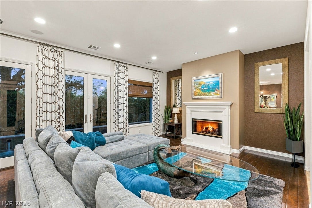 12056 Royal Dolnoch Court, Las Vegas, NV 89141 Rich hardwood floors and a classic fireplace define this inviting living space.