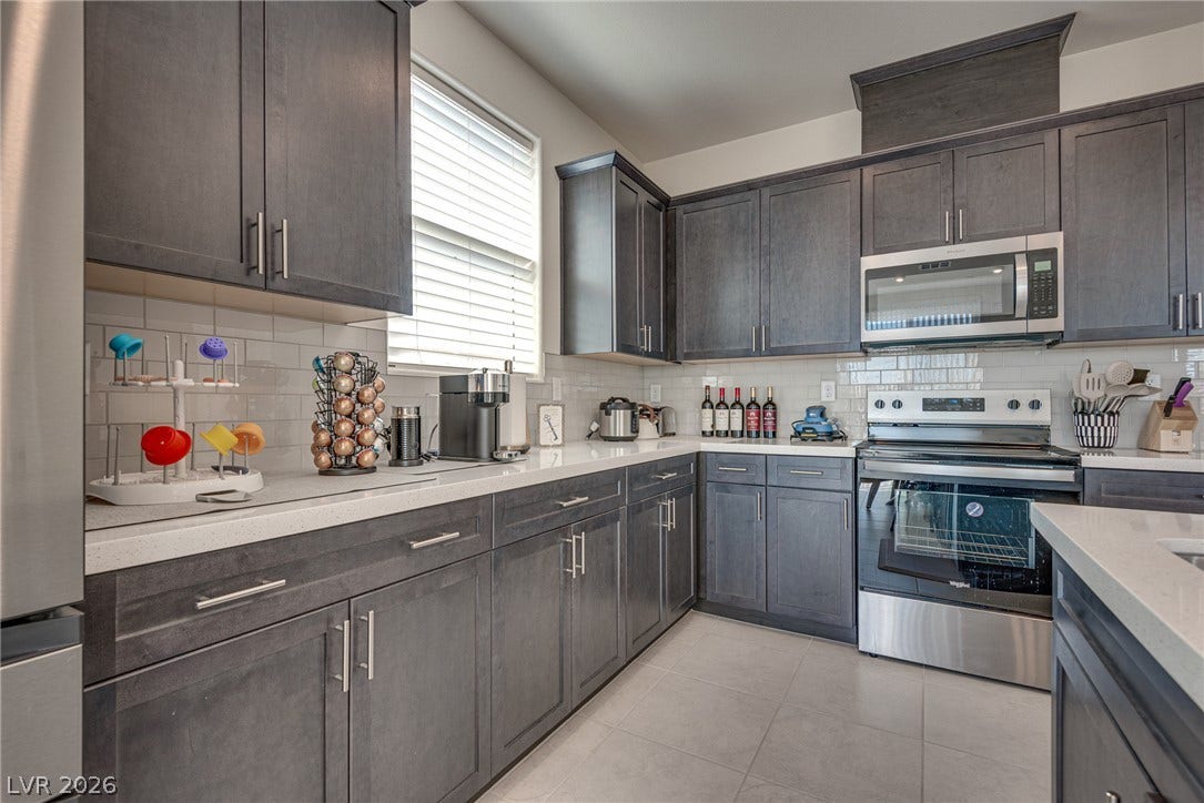 Sleek dark cabinetry and solid stone countertops define this modern culinary workspace.