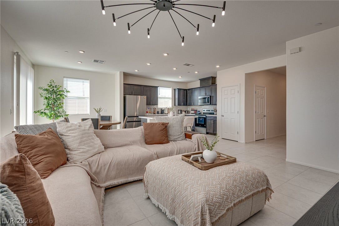 Clean tile flooring and smooth drywall finishes define this modern open-concept space.