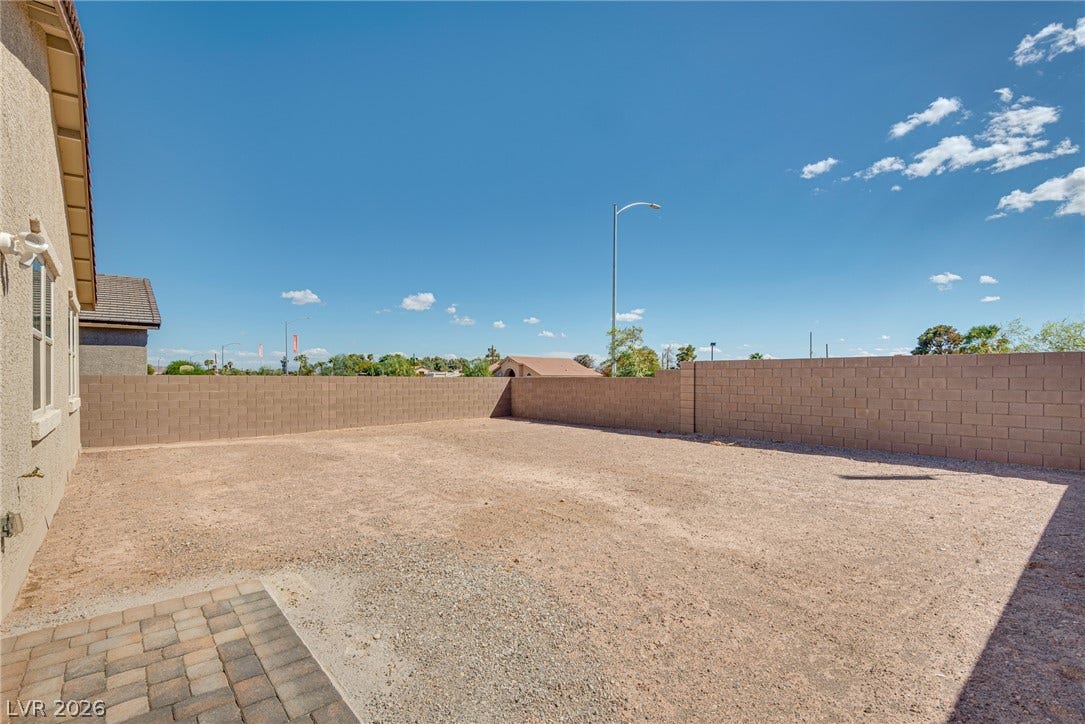 Block walls enclose a spacious backyard presenting a blank slate for custom landscaping designs.