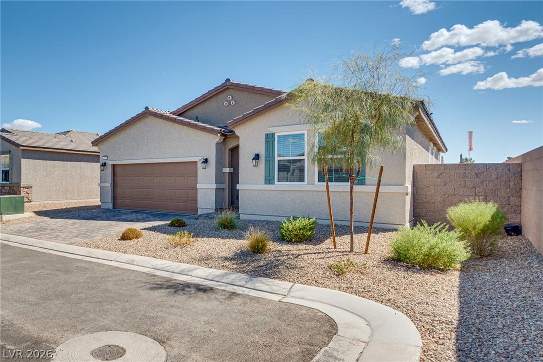 Clean lines and low-maintenance desert landscaping define the exterior of this modern single-story residence.