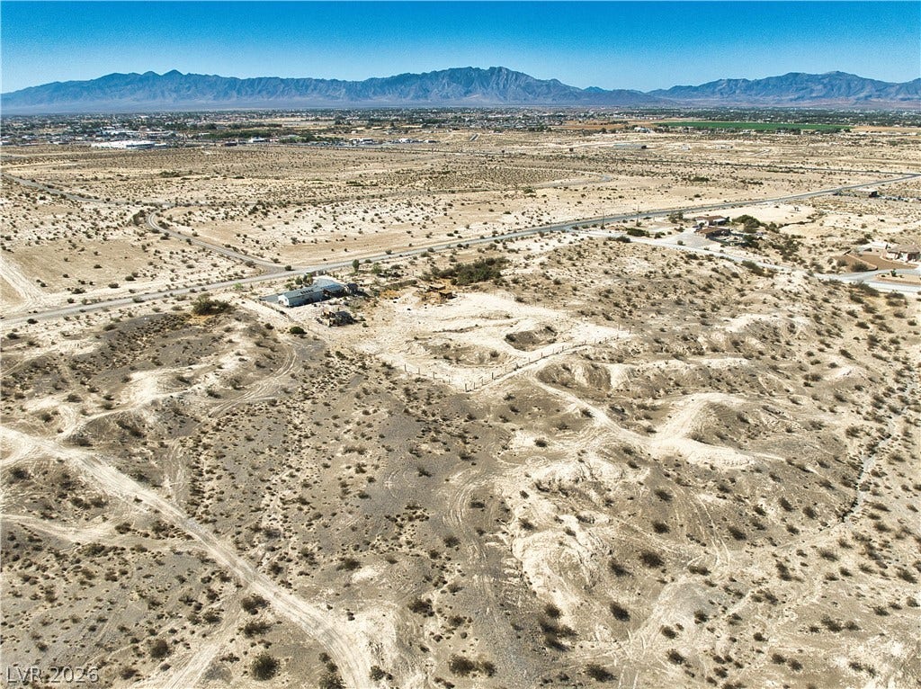 Distant mountains frame this vast desert lot offering endless possibilities.