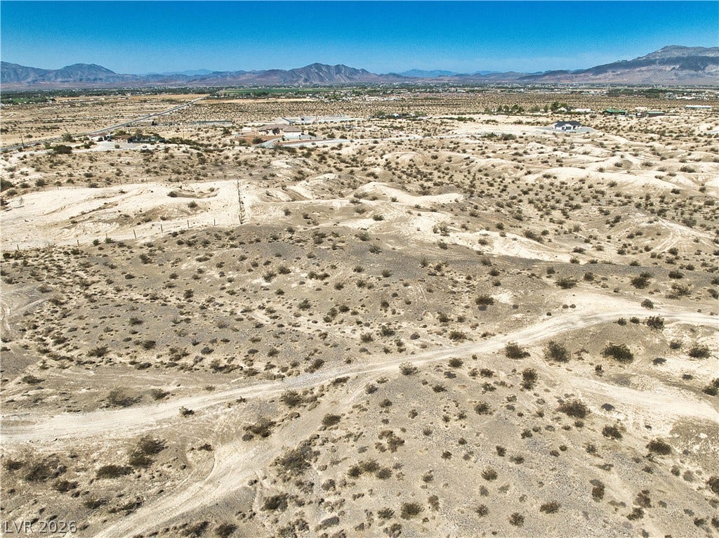 Rugged desert terrain offers sweeping mountain vistas under a clear blue sky.