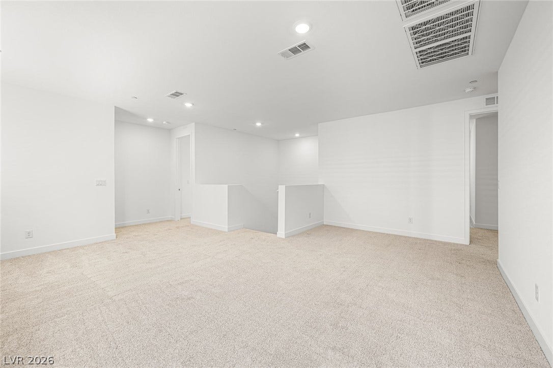 11823 Mimicking Song Lane, Las Vegas, NV 89138 Recessed lighting and wall-to-wall carpeting define this versatile upper-level living space.