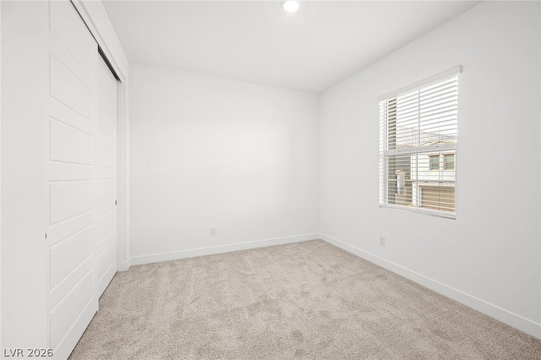 11823 Mimicking Song Lane, Las Vegas, NV 89138 Plush carpeting and a large window create a comfortable and inviting atmosphere.
