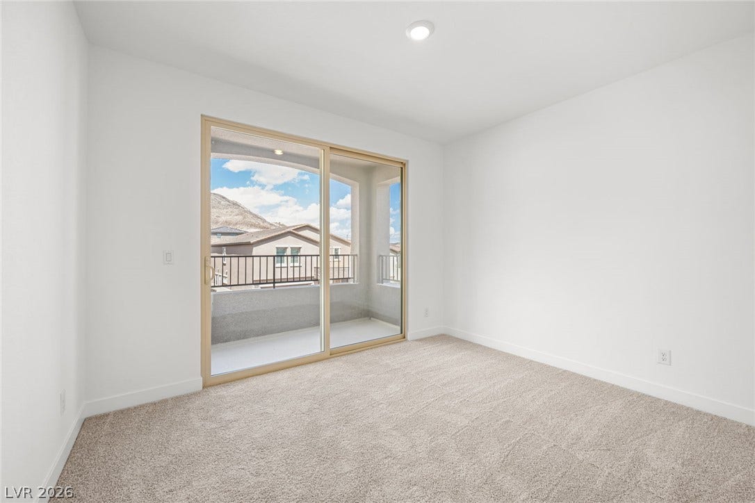 11823 Mimicking Song Lane, Las Vegas, NV 89138 Sliding glass doors open directly to a private balcony from this carpeted bedroom.
