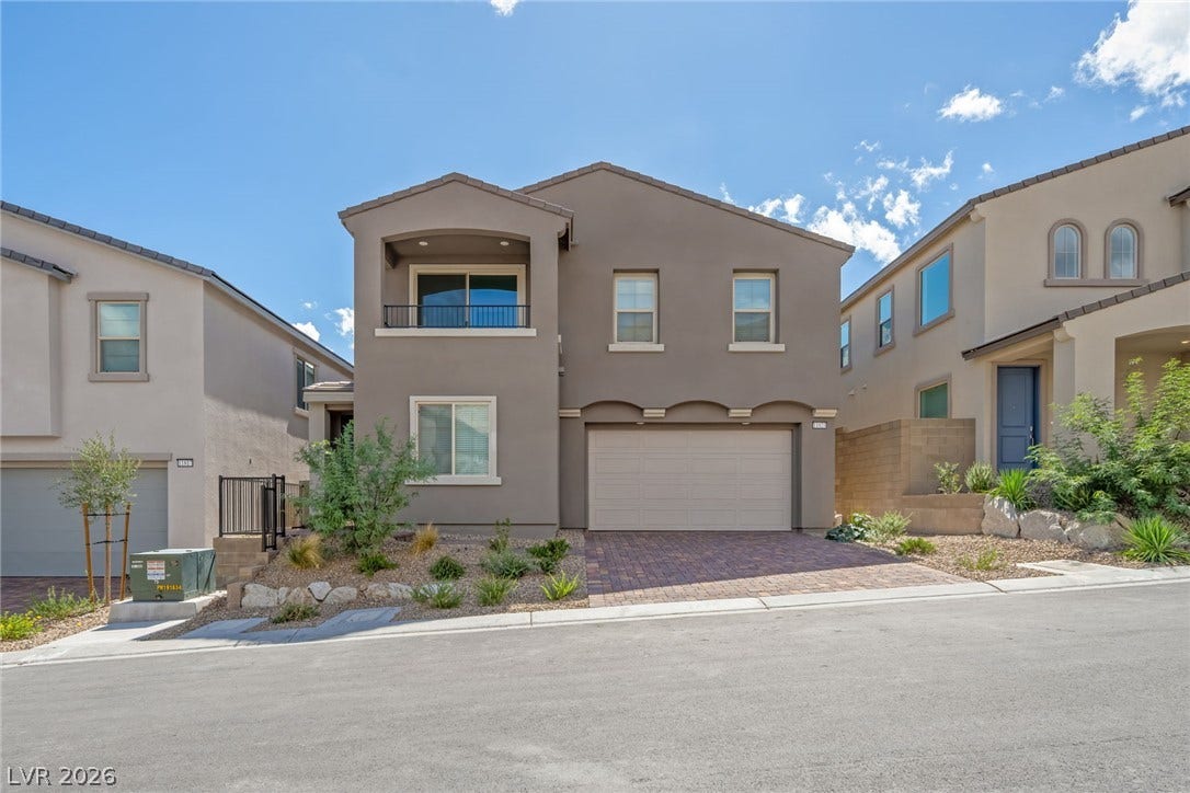 11823 Mimicking Song Lane, Las Vegas, NV 89138 Clean lines and a paved driveway define the exterior of this modern multi-level home.