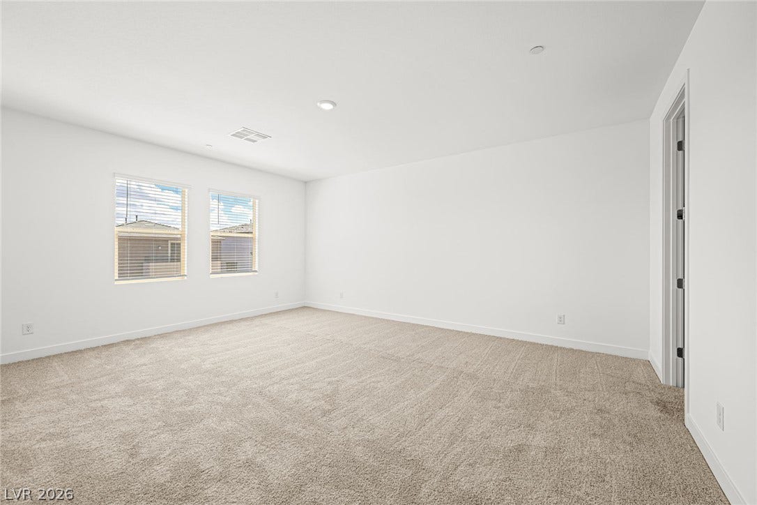 11823 Mimicking Song Lane, Las Vegas, NV 89138 Recessed lighting and soft carpeting create a comfortable atmosphere in this versatile bedroom.