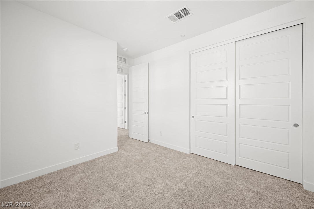 11823 Mimicking Song Lane, Las Vegas, NV 89138 Plush wall-to-wall carpeting and clean lines define this versatile secondary bedroom space.